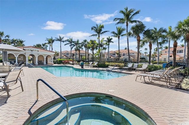 view of pool featuring a community hot tub and a patio area