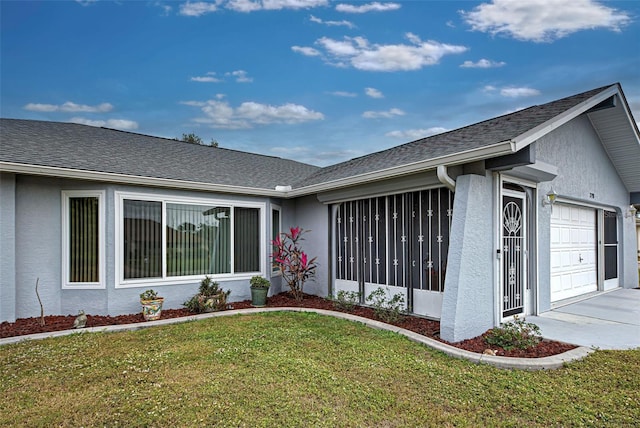 exterior space featuring a lawn and a garage