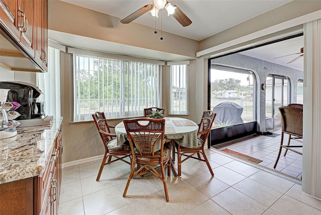 dining area featuring light tile patterned floors and ceiling fan