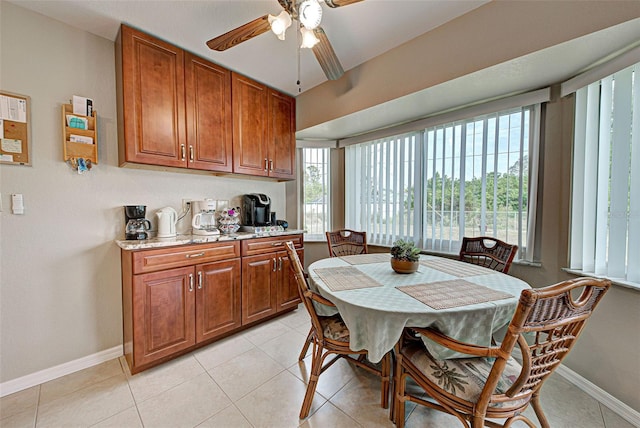 dining room with light tile patterned floors and ceiling fan