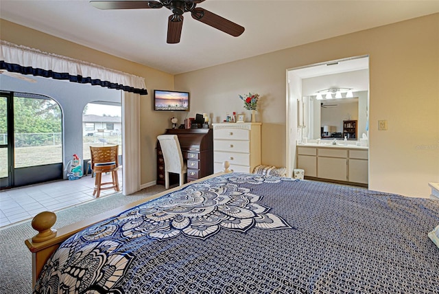 carpeted bedroom featuring ceiling fan, connected bathroom, and access to exterior