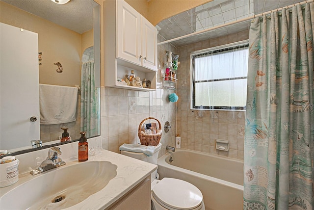 full bathroom with vanity, toilet, tile walls, and shower / bathtub combination with curtain