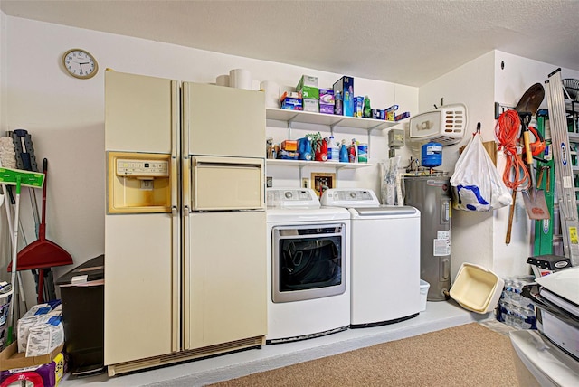 laundry room featuring washer and dryer, electric water heater, and a textured ceiling