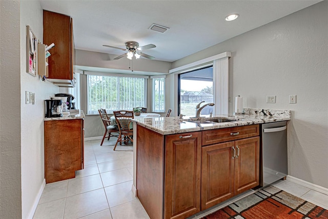 kitchen featuring dishwasher, sink, light tile patterned floors, kitchen peninsula, and light stone countertops