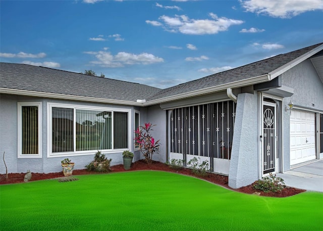 exterior space with a garage and a lawn