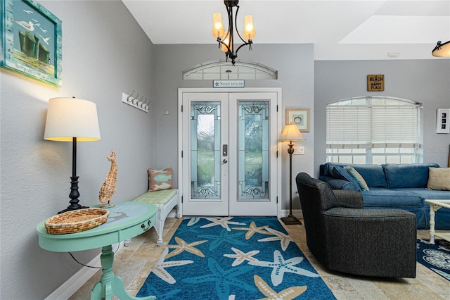 entrance foyer with french doors and a notable chandelier