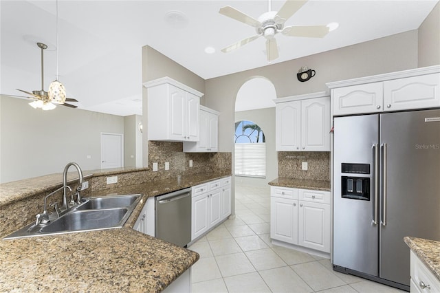 kitchen featuring sink, white cabinetry, appliances with stainless steel finishes, and tasteful backsplash