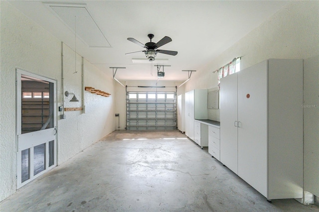 garage with ceiling fan and a garage door opener