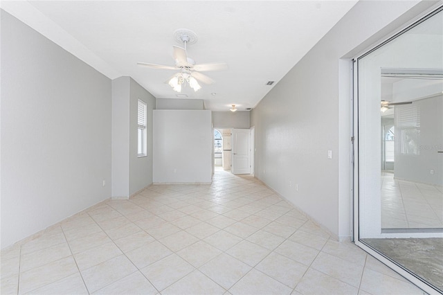 tiled empty room with ceiling fan