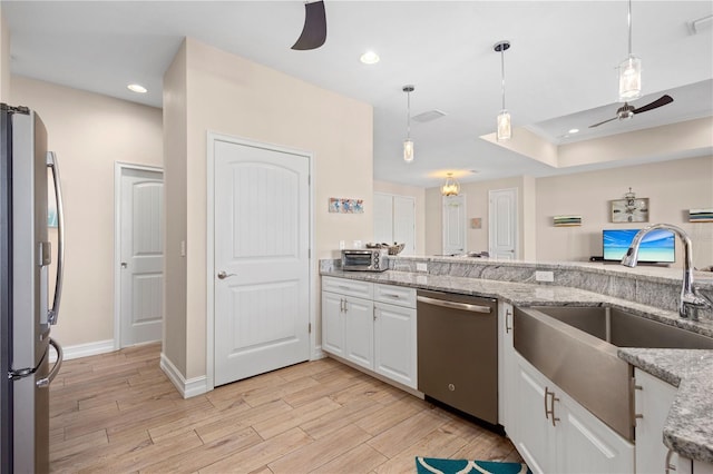 kitchen featuring white cabinetry, appliances with stainless steel finishes, sink, and ceiling fan