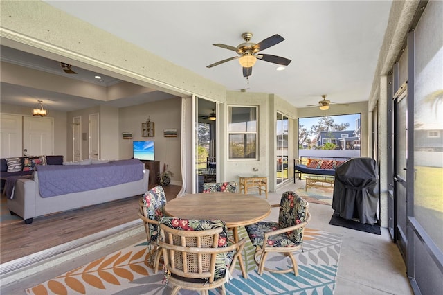 sunroom featuring ceiling fan