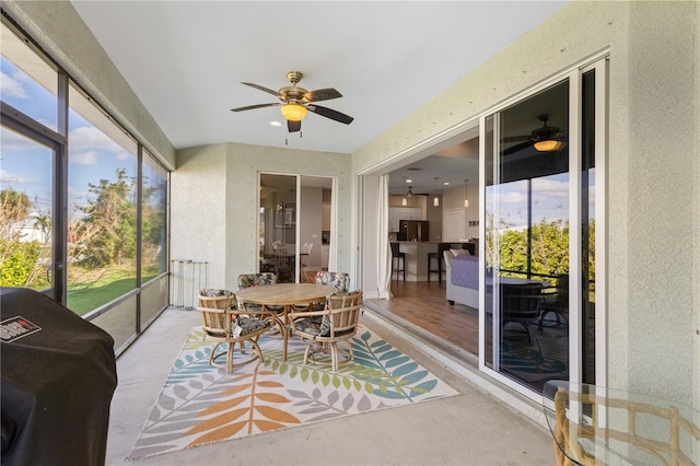 sunroom featuring ceiling fan