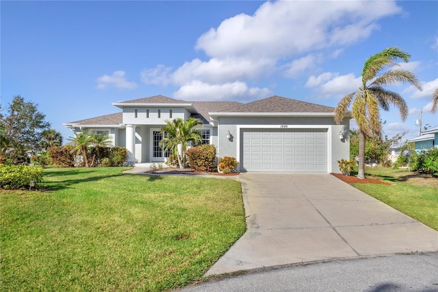 view of front of property featuring a garage and a front lawn