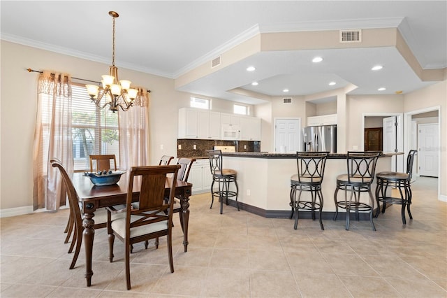 tiled dining area featuring ornamental molding and a notable chandelier