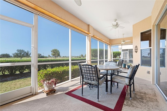 sunroom with ceiling fan and a wealth of natural light