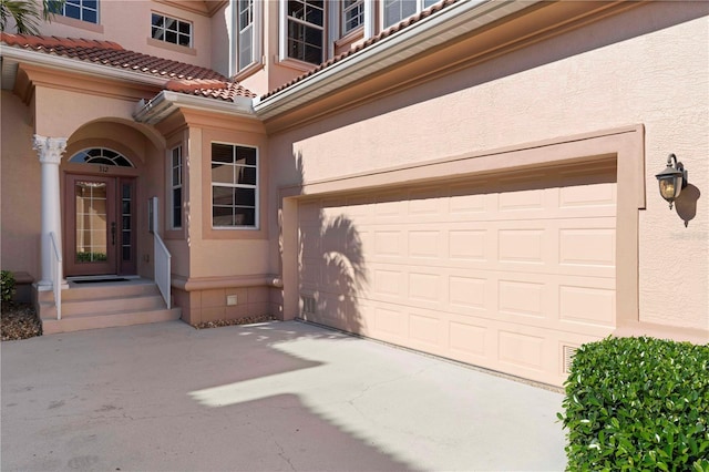 doorway to property with a garage