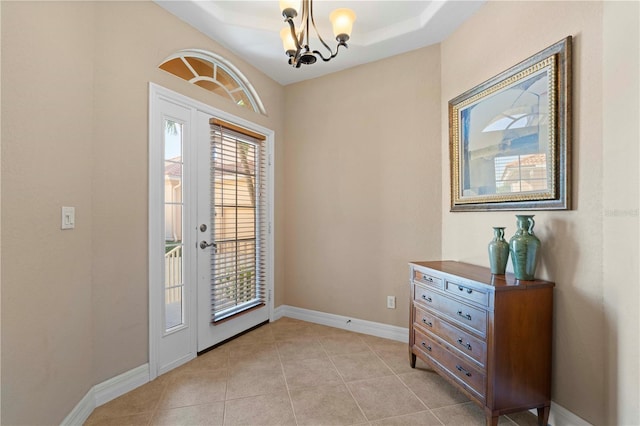 doorway featuring light tile patterned flooring, an inviting chandelier, and a wealth of natural light