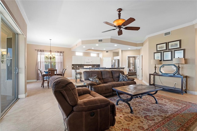 tiled living room with ceiling fan with notable chandelier and crown molding