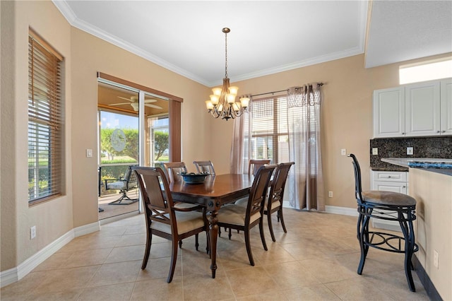 tiled dining room featuring an inviting chandelier and ornamental molding