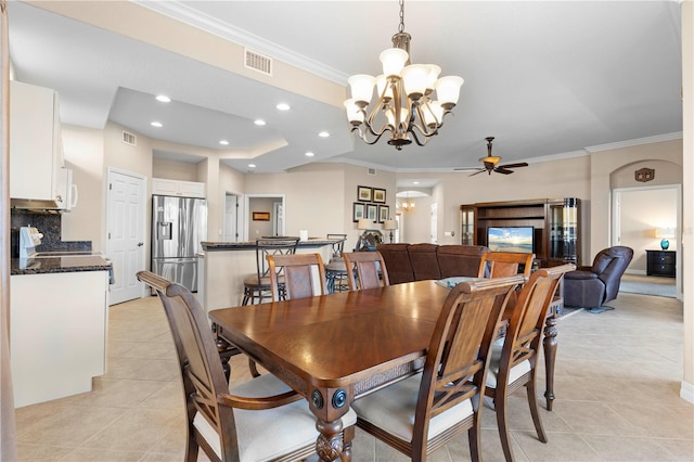 tiled dining space with ceiling fan with notable chandelier and ornamental molding