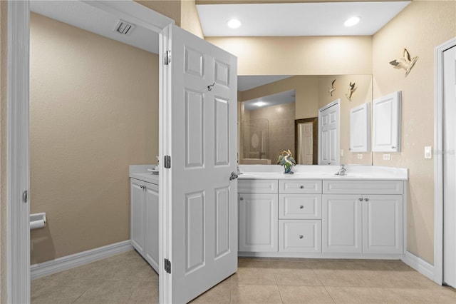 bathroom with tile patterned floors and vanity