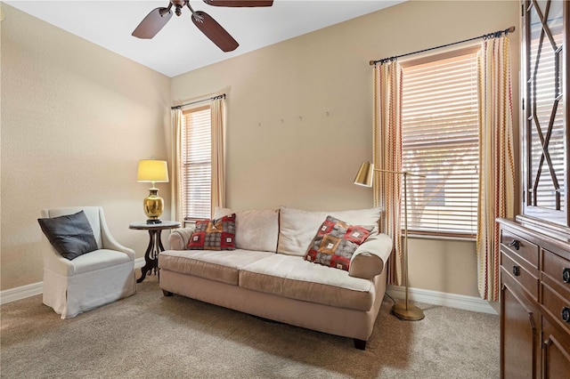 living room featuring ceiling fan and light colored carpet