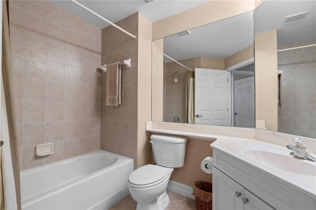 full bathroom featuring toilet, a textured ceiling, tile patterned flooring, tiled shower / bath combo, and vanity