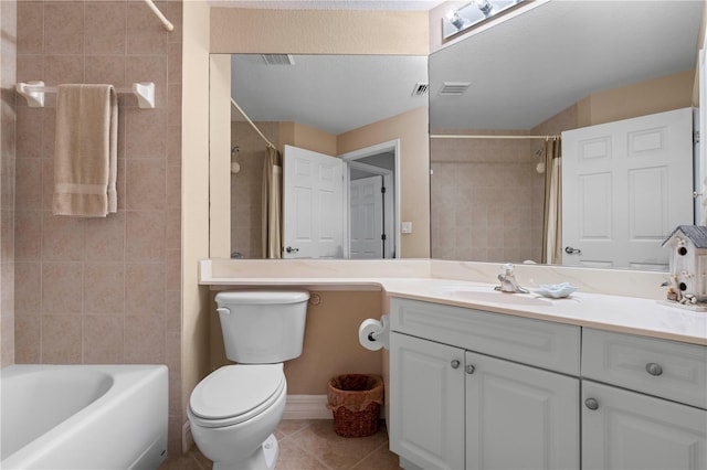 full bathroom featuring vanity, tile patterned flooring, toilet, and tiled shower / bath