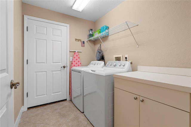 washroom with washing machine and clothes dryer and light tile patterned floors