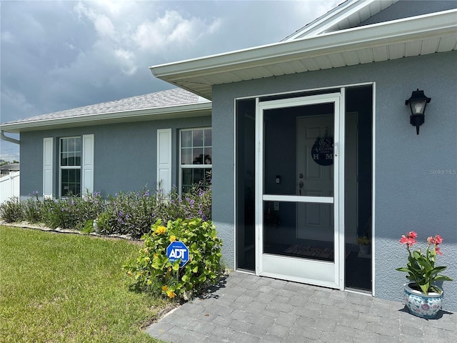 doorway to property featuring a yard