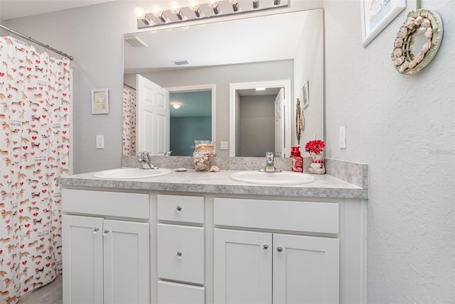 bathroom featuring a shower with curtain and vanity