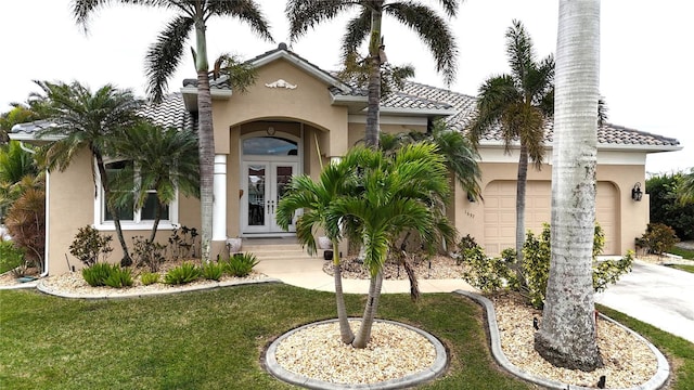 mediterranean / spanish home with a front yard and a garage