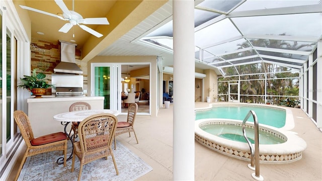 view of pool with a lanai, exterior kitchen, a patio area, and an in ground hot tub