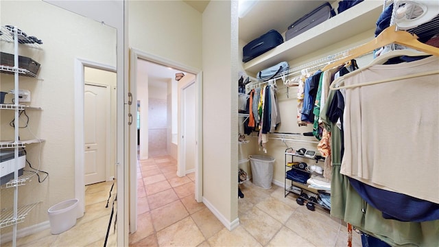 spacious closet with light tile patterned floors