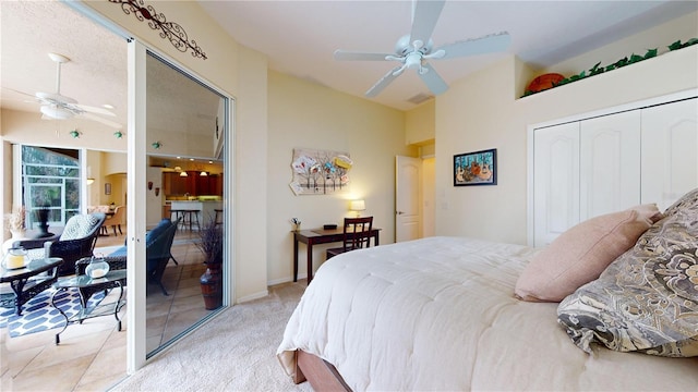 carpeted bedroom featuring ceiling fan and a closet