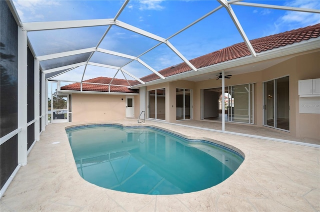 view of pool featuring ceiling fan, a lanai, and a patio area