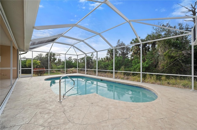 view of swimming pool with a patio area and glass enclosure