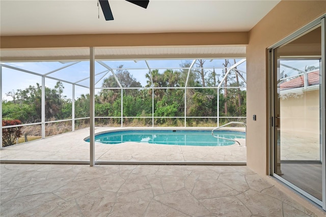 view of pool featuring ceiling fan, a patio, and glass enclosure