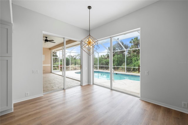 unfurnished dining area with ceiling fan and hardwood / wood-style floors