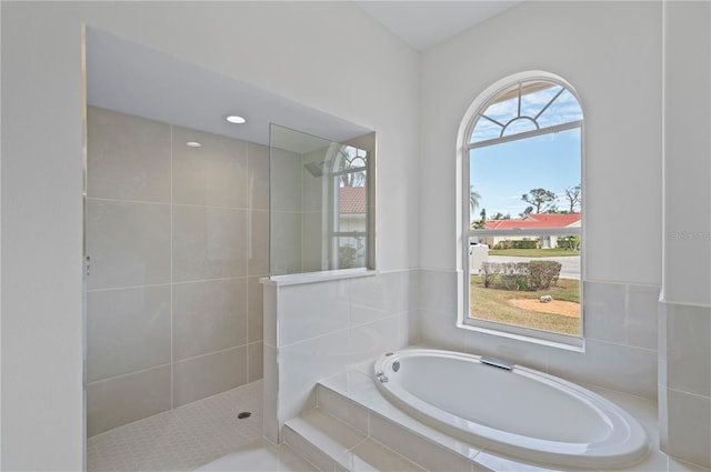 bathroom featuring independent shower and bath