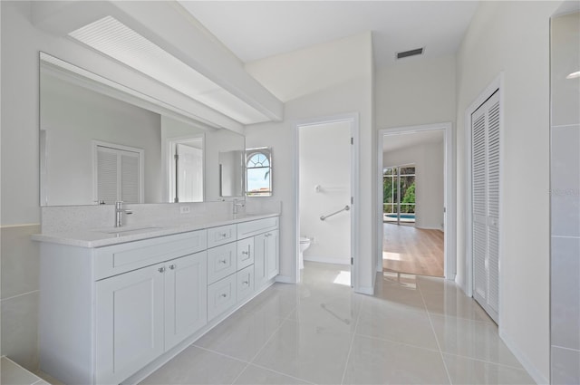 bathroom featuring tile patterned flooring, vanity, and toilet