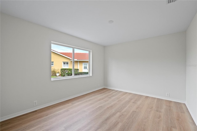 spare room with light wood-type flooring