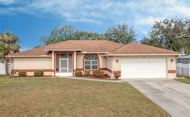 ranch-style house featuring a front yard and a garage