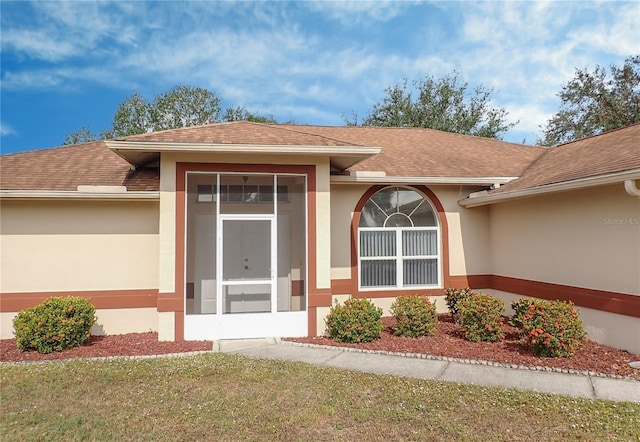 property entrance with a yard