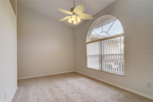 carpeted spare room with ceiling fan