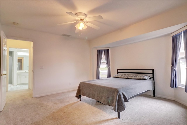 bedroom with ceiling fan and light carpet