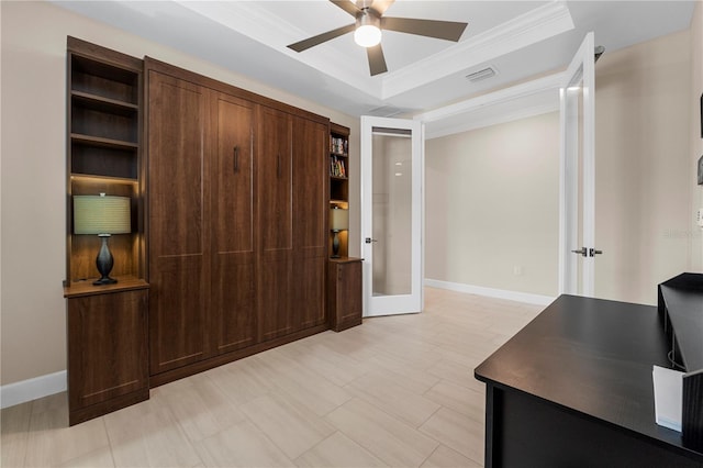 home office featuring ceiling fan, ornamental molding, a raised ceiling, and french doors