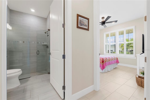 bathroom with toilet, ceiling fan, tile patterned floors, and a shower with door