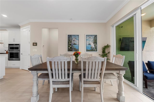 dining area with light tile patterned floors and crown molding