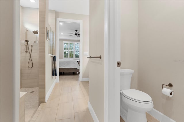 bathroom featuring ceiling fan, tiled shower, toilet, and tile patterned flooring